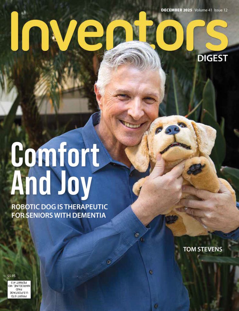 A smiling older man with gray hair stands outdoors holding a plush robotic dog against his cheek. He wears a blue button-down shirt, and tall green plants fill the background. The magazine title “Inventors Digest” appears at the top, with the headline “Comfort and Joy: Robotic dog is therapeutic for seniors with dementia.”