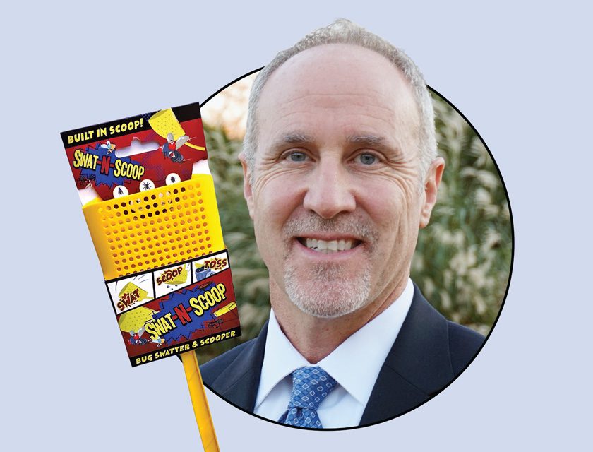 Portrait of Scott Putnam with Swat-N-Scoop bug swatter and scooper product packaging, smiling outdoors in business attire